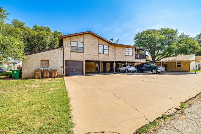 view of front of home with a garage and a front lawn