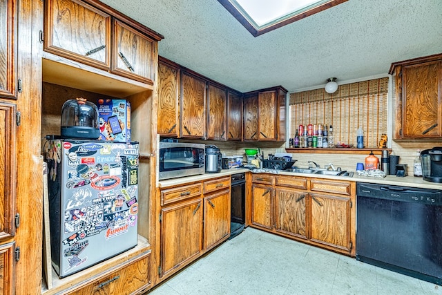 kitchen featuring sink, a textured ceiling, and black dishwasher