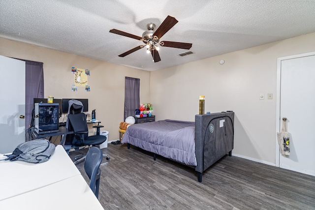 bedroom with ceiling fan, a textured ceiling, and dark hardwood / wood-style flooring