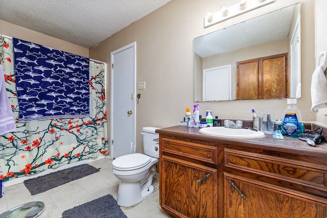 bathroom featuring vanity, a textured ceiling, and toilet