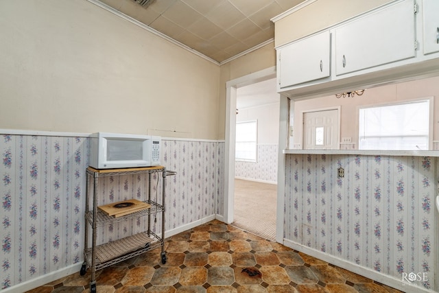 interior space featuring white cabinetry and ornamental molding