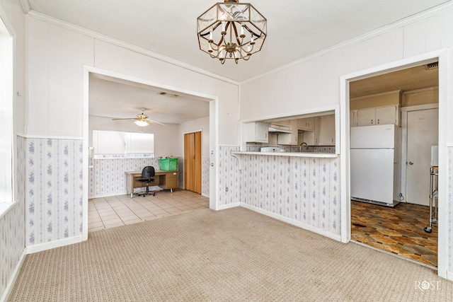 unfurnished living room with ornamental molding, carpet, sink, and ceiling fan with notable chandelier