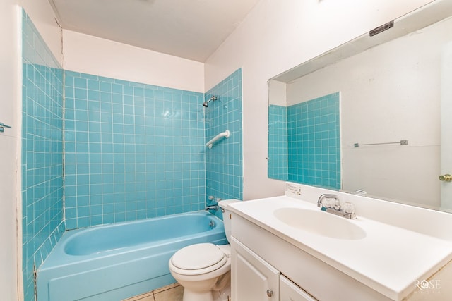 full bathroom featuring tiled shower / bath, vanity, and toilet