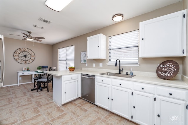 kitchen with visible vents, dishwasher, a peninsula, a ceiling fan, and a sink