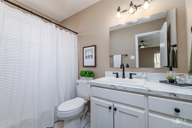 bathroom with toilet, ceiling fan, and vanity