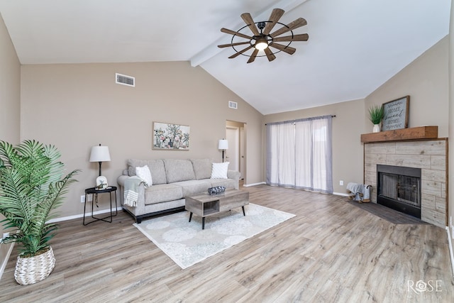 living room featuring wood finished floors, a ceiling fan, visible vents, and beam ceiling