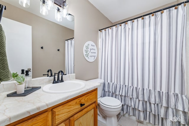 bathroom featuring vanity, tile patterned floors, and toilet