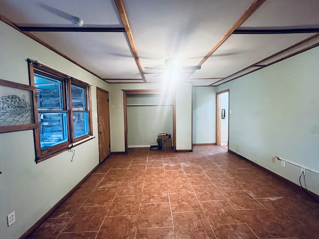 spare room featuring baseboards