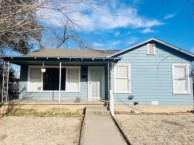 view of front of home with covered porch and roof with shingles