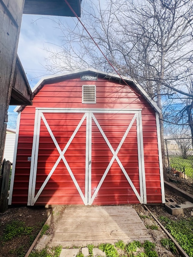 view of shed featuring fence