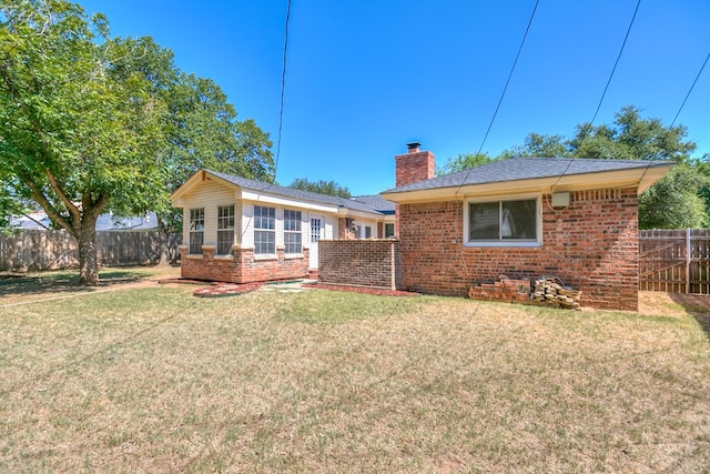 rear view of house with a lawn