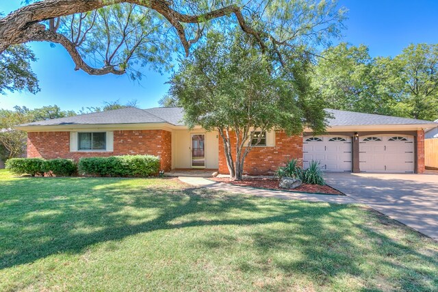 ranch-style house with a garage and a front yard