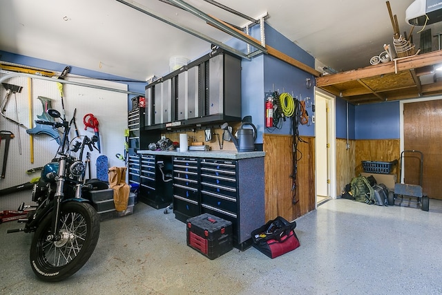 garage featuring wooden walls and a workshop area