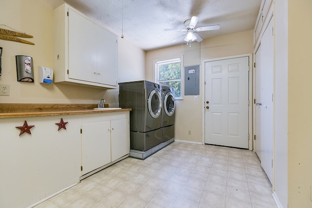 laundry area with cabinets, a textured ceiling, electric panel, ceiling fan, and washing machine and dryer