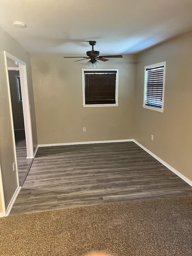 unfurnished room with ceiling fan and dark hardwood / wood-style flooring