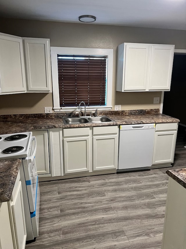 kitchen featuring white cabinetry, sink, white appliances, and light hardwood / wood-style flooring