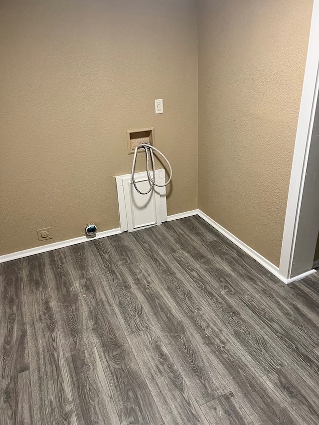 laundry room featuring dark wood-type flooring and washer hookup