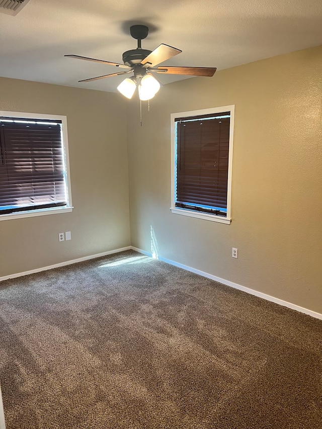 spare room featuring carpet floors and ceiling fan