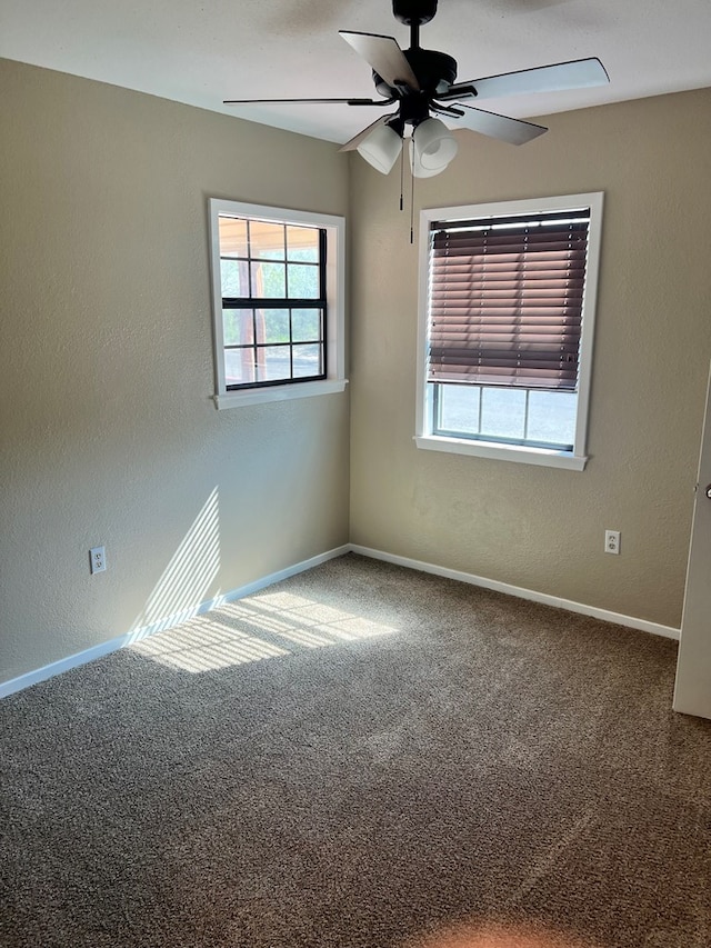 empty room featuring carpet floors and ceiling fan