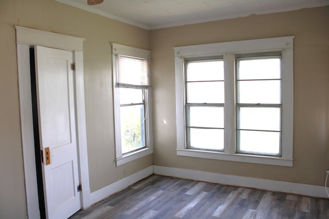 1002 Broadway St, Ballinger, TX 76821 - empty room with wood finished floors, plenty of natural light, and ornamental molding