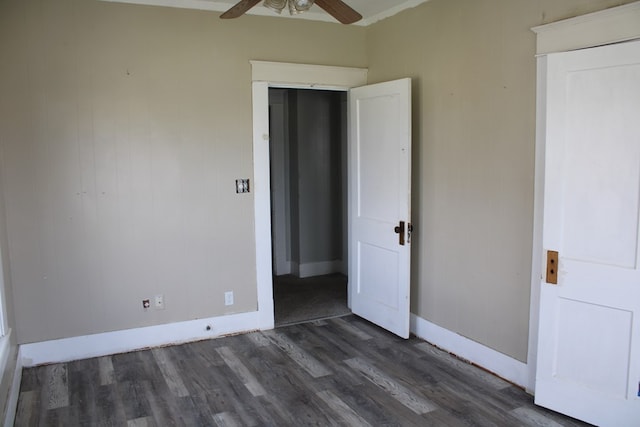 1002 Broadway St, Ballinger, TX 76821 - unfurnished bedroom featuring dark wood finished floors and ceiling fan