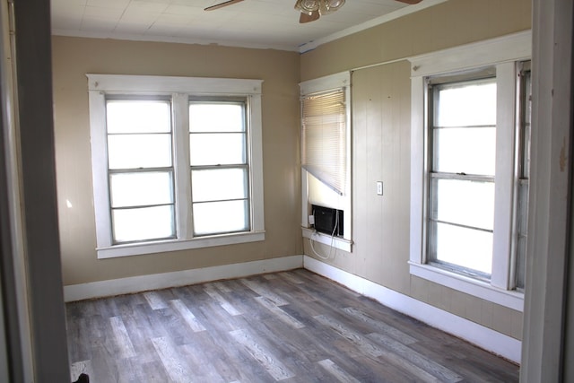 1002 Broadway St, Ballinger, TX 76821 - empty room with ceiling fan, wood finished floors, ornamental molding, and cooling unit