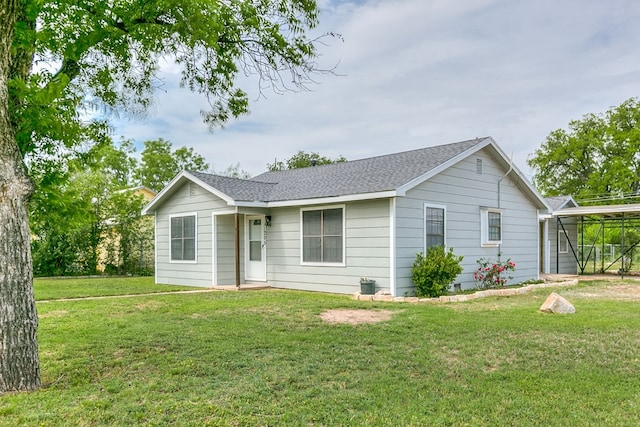 ranch-style house with a shingled roof and a front yard