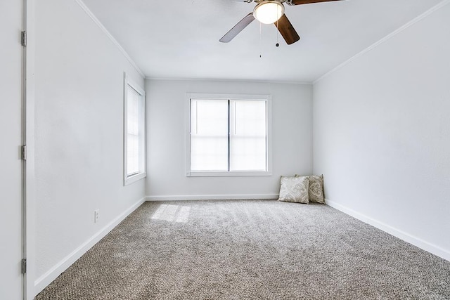 empty room with crown molding, ceiling fan, baseboards, and carpet