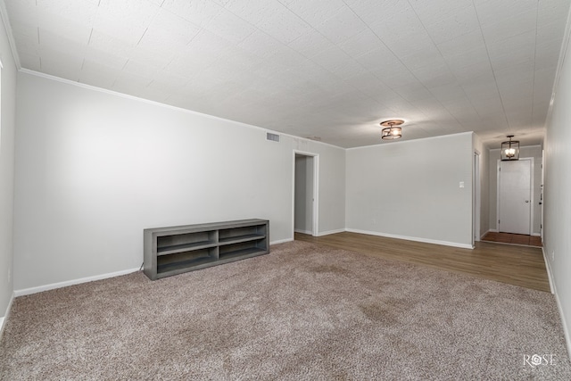 unfurnished living room featuring crown molding and carpet