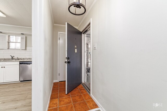 hallway featuring ornamental molding and sink