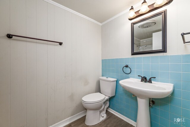 bathroom featuring crown molding, wood-type flooring, and toilet