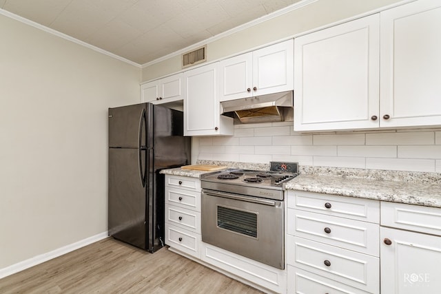 kitchen featuring ornamental molding, white cabinets, stainless steel range oven, decorative backsplash, and black fridge