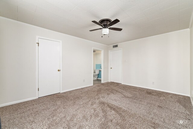 empty room with crown molding, ceiling fan, and carpet floors