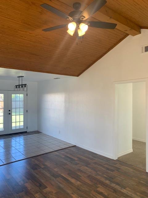 unfurnished room featuring french doors, vaulted ceiling with beams, wood ceiling, dark hardwood / wood-style floors, and ceiling fan