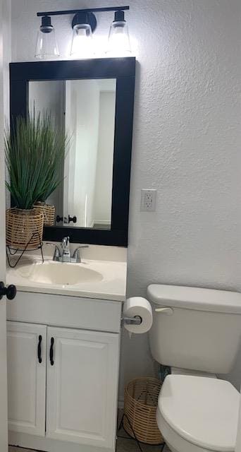 bathroom with vanity, tile patterned flooring, and toilet