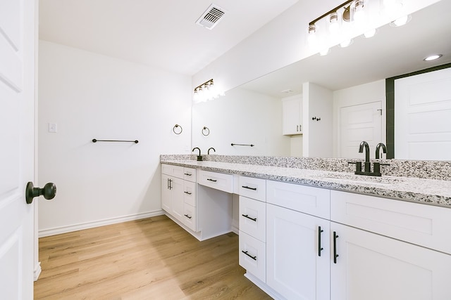 bathroom with vanity and hardwood / wood-style flooring