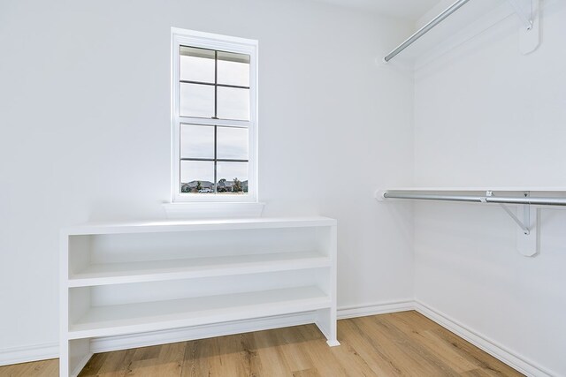 spacious closet featuring hardwood / wood-style flooring