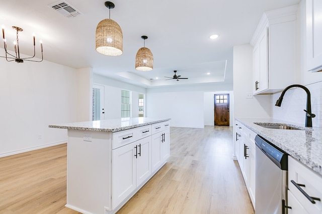 kitchen with sink, dishwasher, a raised ceiling, and white cabinets