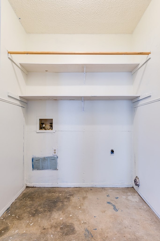 laundry area with laundry area, hookup for a washing machine, hookup for an electric dryer, and a textured ceiling