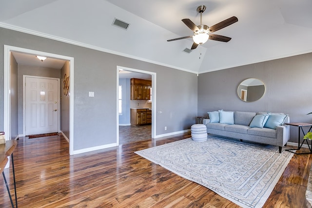 living room featuring visible vents, ornamental molding, wood finished floors, baseboards, and vaulted ceiling