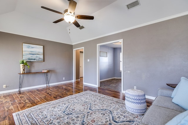 living area featuring visible vents, baseboards, lofted ceiling, and wood finished floors