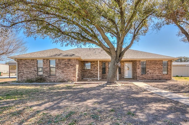 single story home with brick siding and roof with shingles