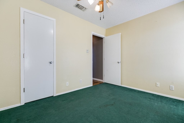 unfurnished bedroom with baseboards, carpet, visible vents, and a textured ceiling