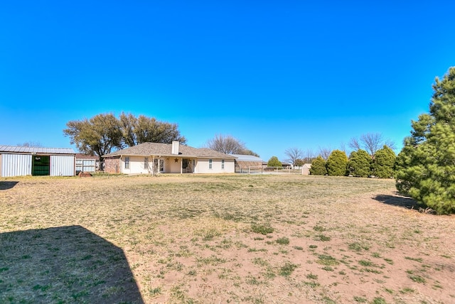 view of yard featuring an outbuilding and fence