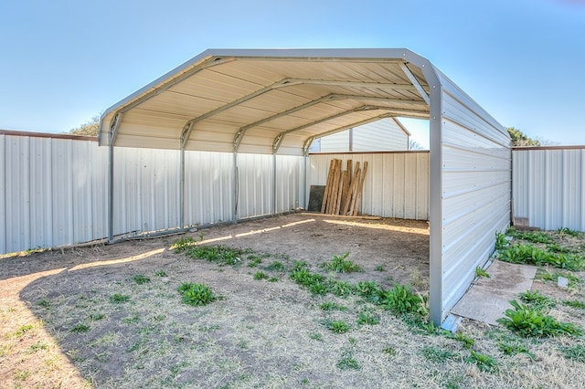 exterior space with a detached carport and fence