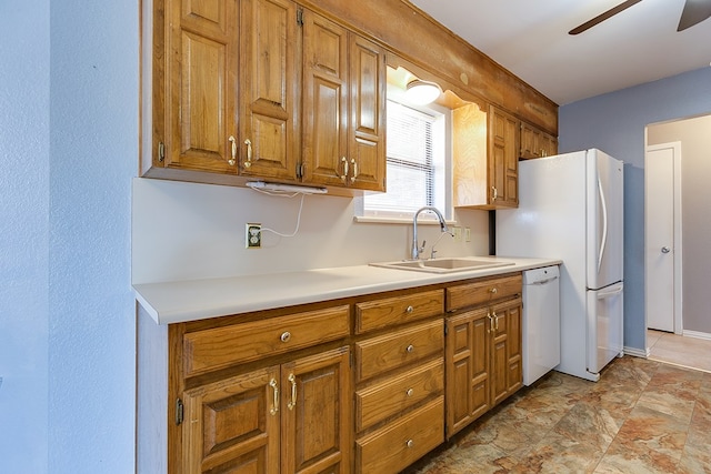 kitchen featuring light countertops, brown cabinets, white appliances, a ceiling fan, and a sink