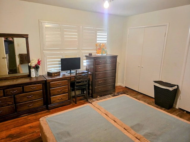 bedroom with dark wood-style flooring