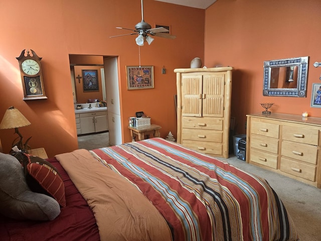 bedroom featuring light colored carpet and ensuite bathroom