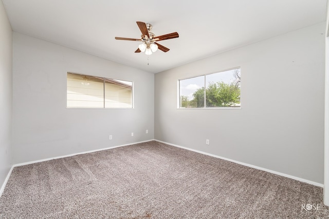 unfurnished room with carpet, ceiling fan, and baseboards