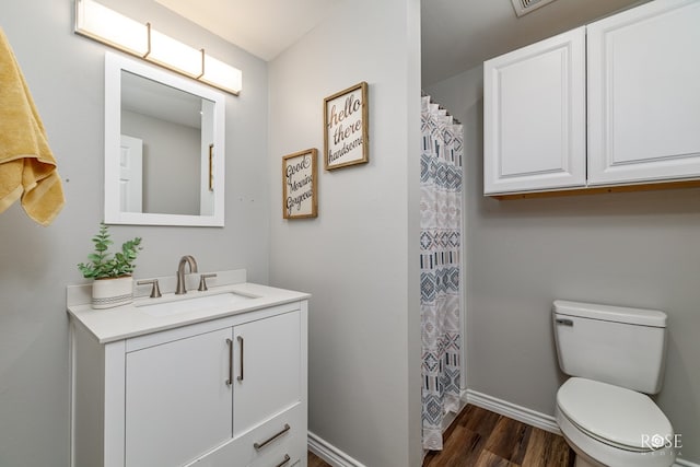 full bathroom with wood finished floors, toilet, vanity, baseboards, and curtained shower